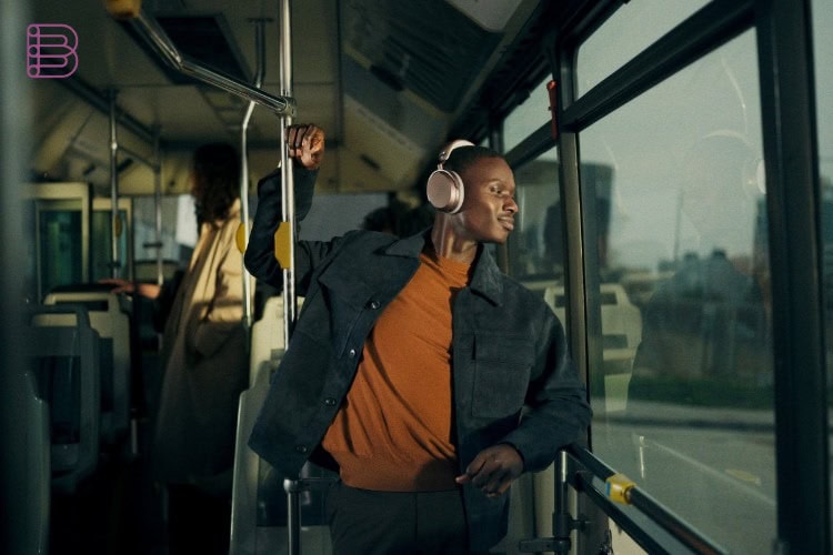 A commuter wearing Sennheiser MOMENTUM 5 Wireless headphones