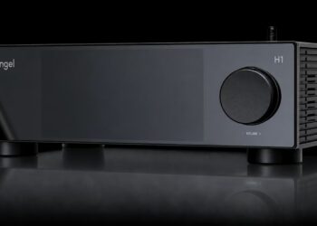 Silent Angel H1 Pure Music Hub in black with large volume knob, dark display panel and two antennas on a reflective surface