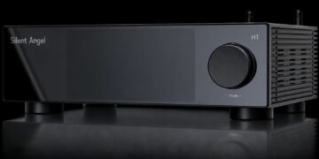 Silent Angel H1 Pure Music Hub in black with large volume knob, dark display panel and two antennas on a reflective surface