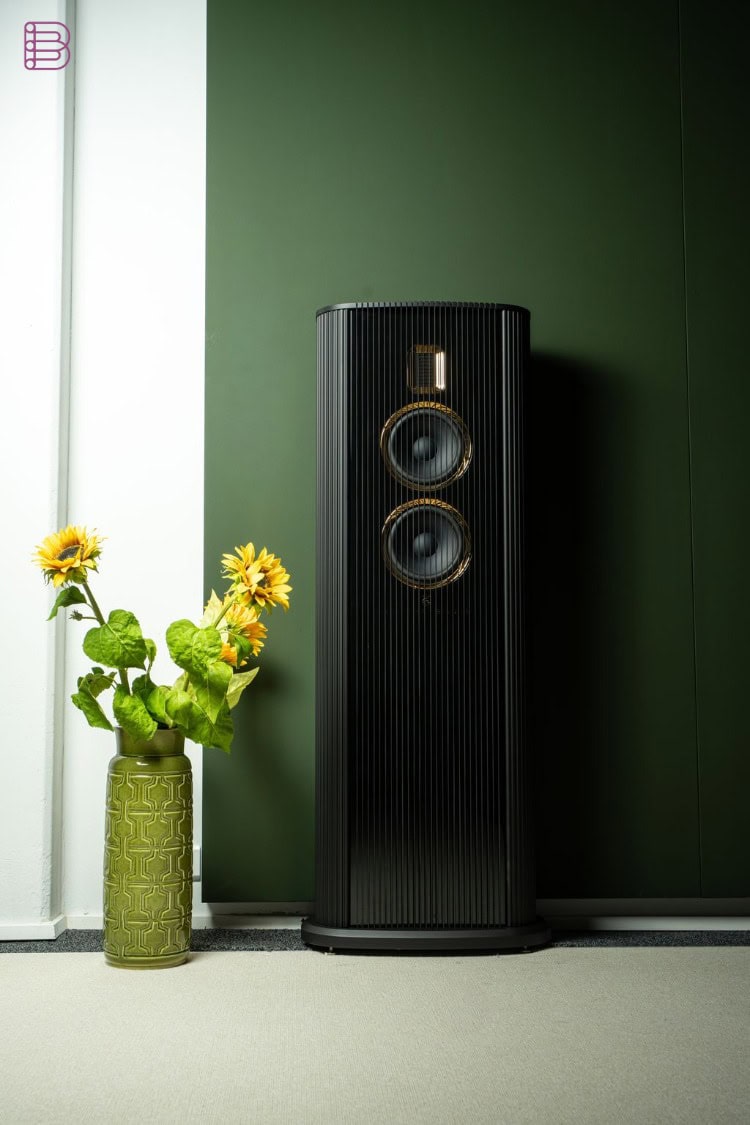 Steinway Lyngdorf Model O loudspeaker placed against a wall in a living room setting