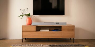 Teufel Cinebar Pro 2 soundbar and subwoofer set below a wall-mounted TV