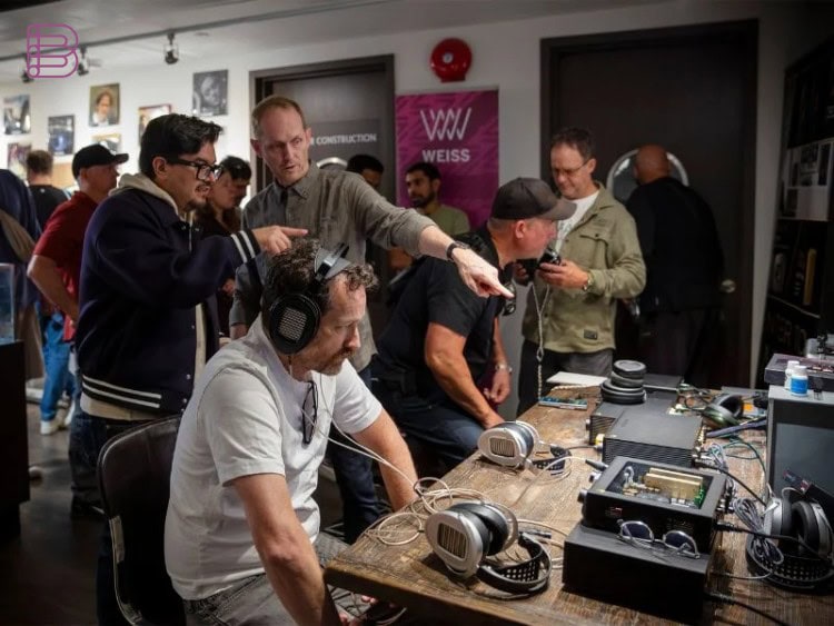 Crowd of visitors trying out headphones at demo tables during the Vancouver Headphone Festival