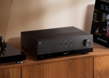 Yamaha R200A stereo receiver in a home listening setup with speakers and turntable