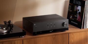 Yamaha R200A stereo receiver in a home listening setup with speakers and turntable