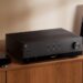Yamaha R200A stereo receiver in a home listening setup with speakers and turntable